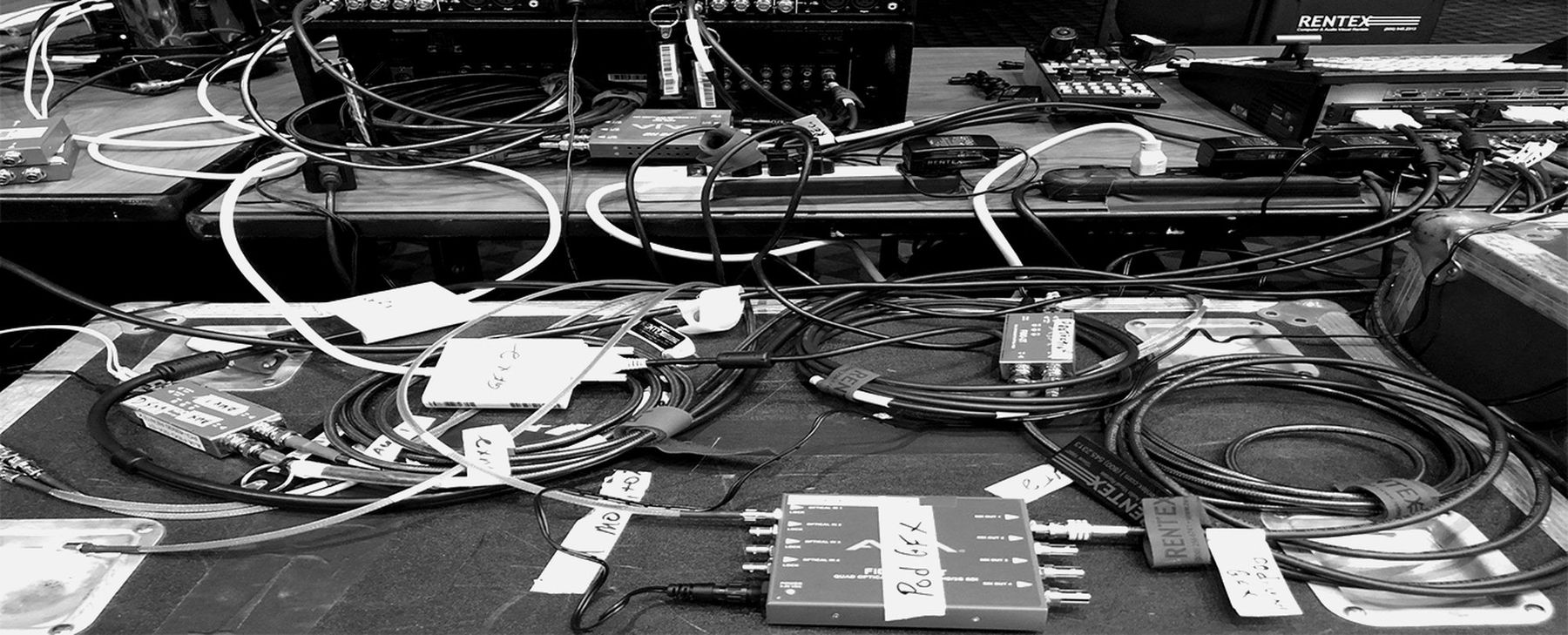 Fibre, BNC and power runs labelled and laid out on a show floor.